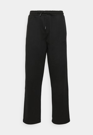 Sorte sweatpants lavet af blødt stof, med en elastisk talje med snøre, sidesøm og et lille logo-detalje på benet.