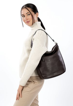 Brown leather shoulder bag with a smooth texture and a curved top. Features a single adjustable strap and a zipper closure.