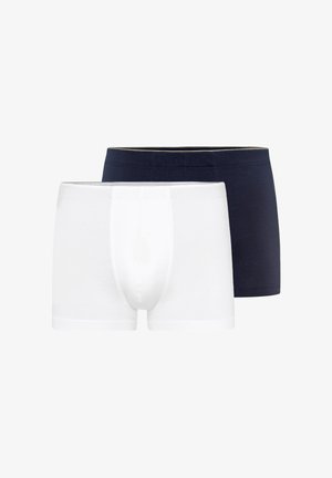 Due boxer da uomo aderenti, uno bianco davanti e uno nero dietro, esposti su uno sfondo bianco.