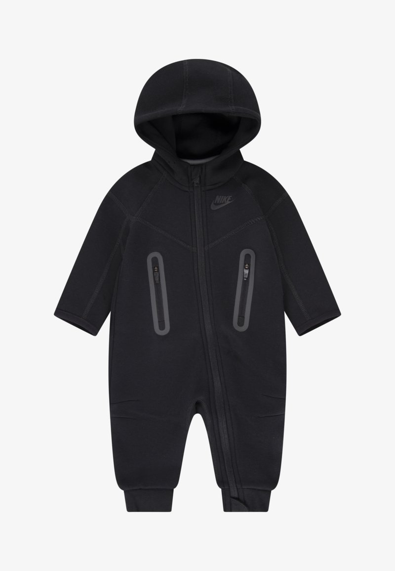 Black Nike jumpsuit featuring a zip closure, hood, and two zippered pockets. Made from a smooth, stretchy fabric with subtle seams.