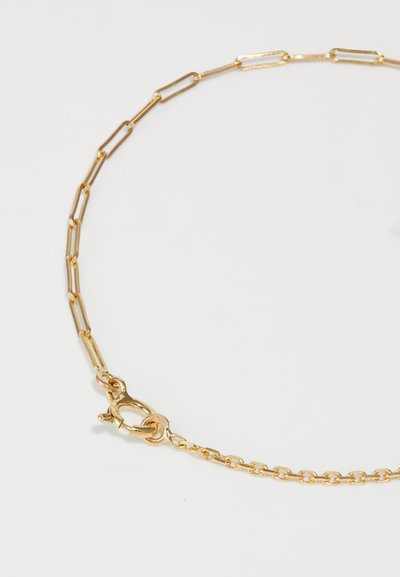 Gold chain necklace featuring elongated, linked segments and a secure lobster clasp. Smooth texture with a shiny finish.