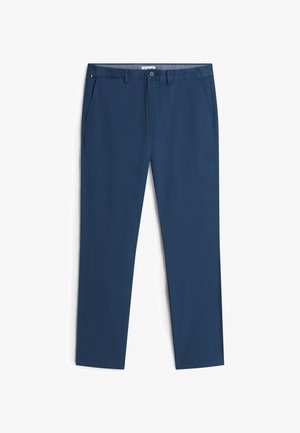 Navy blue straight-leg pants with belt loops, front button, zipper, side pockets, and a small red-white-blue flag detail on the left pocket.