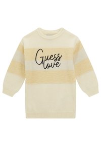 Maglione color crema con strisce gialle e avorio. Presenta un collo rotondo e la scritta "Guess love" in corsivo nero sul davanti.