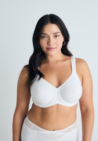 White bra with a structured design, underwire support, smooth texture, and adjustable straps; features a seamless cup and classic silhouette.