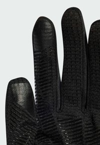 Svarta handskar med en texturerad tygkonstruktion som har ribbstruktur, släta fingertoppsektioner och en figurnära design.