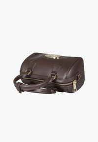 Borsa a mano in pelle marrone scuro con doppi manici, cerniera dorata e targhetta metallica del marchio sulla parte superiore, esposta su uno sfondo bianco semplice.