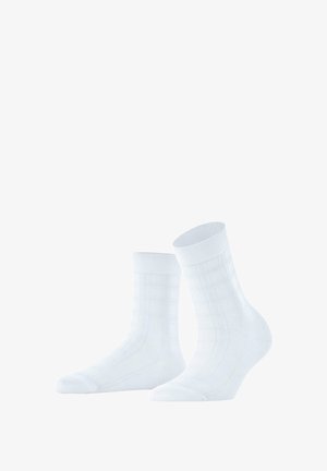 White socks with a textured grid pattern and ribbed cuffs, made of soft fabric with a smooth finish, designed for comfort.