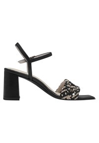 Svart och cream vävd sandal med klack, öppen tå och justerbart ankelsnöre. Har en slät läderfinish och texturerad överdel.