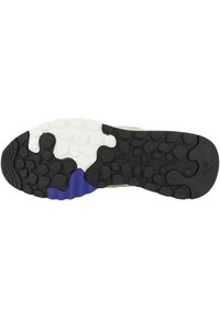 Suola di scarpa in gomma nera e bianca con motivi circolari, caratterizzata da un accento blu e una superficie texture per una migliore aderenza.