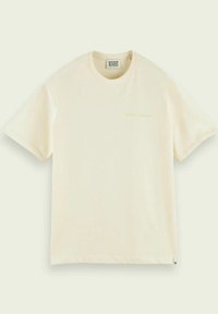T-shirt in cotone color crema con maniche corte. Presenta un piccolo logo verde sul lato sinistro anteriore. Design semplice con scollatura tonda.