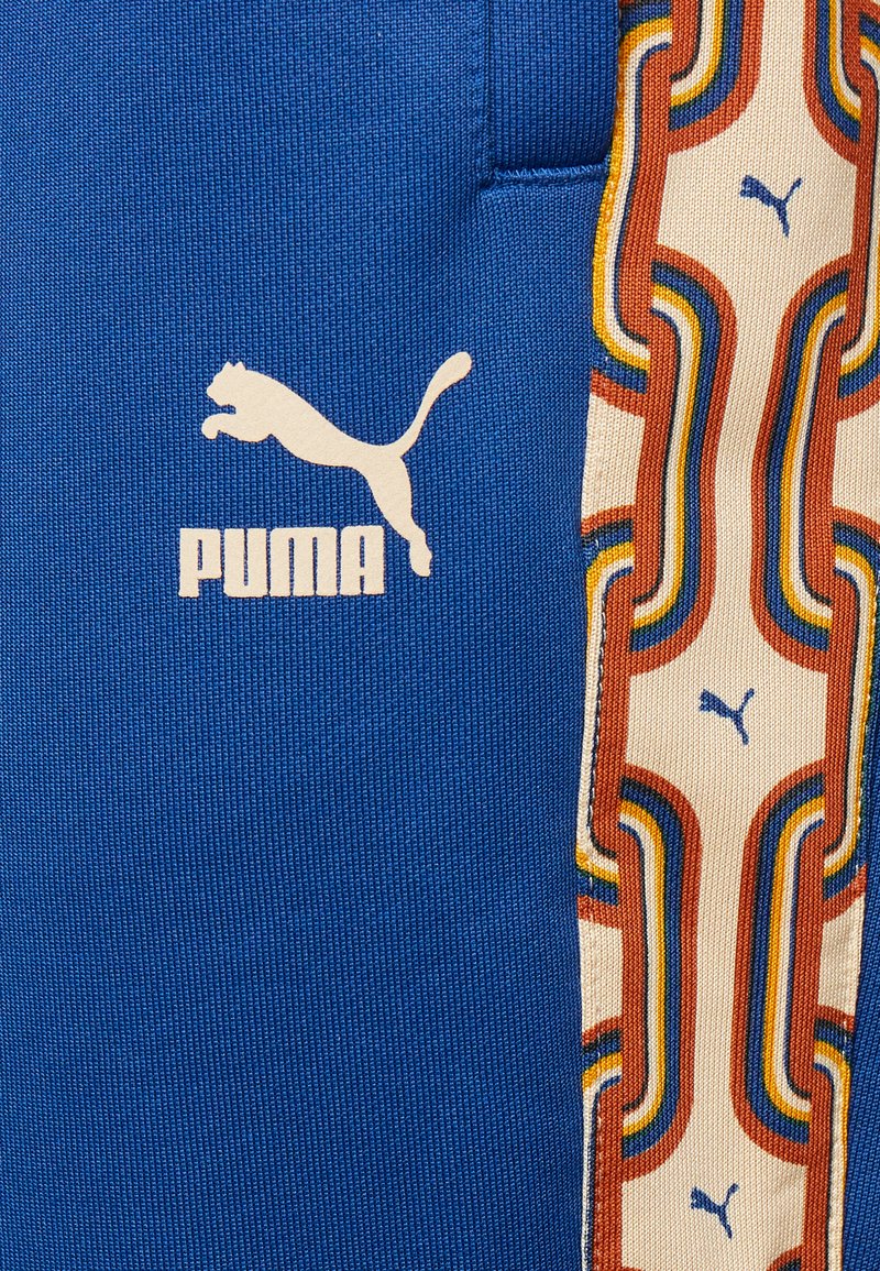Puma PSCHEDELIC TRACK PANTS - Teplákové kalhoty - blazing blue