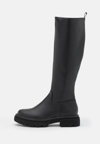 Black knee-high boot made of smooth, matte material with a chunky sole, rounded toe, and a pull tab at the top for easy wearing.