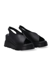 Zwarte open teen platform wedge schoenen met een slingback ontwerp, gemaakt van soepel leer met een geribbelde tussenzool en een gestructureerde buitenzool.