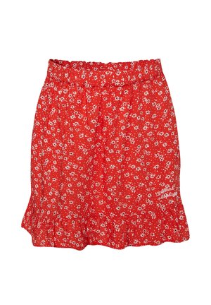 Roter Blumenrock mit weißem Gänseblümchenmuster, elastischem Bund, Rüschensaum und kleinem Kursivtext unten rechts.