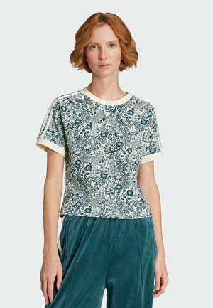 T-shirt a maniche corte color crema con stampa floreale verde scuro, scollatura rotonda e orli delle maniche a contrasto. Tessuto morbido e flessibile con una vestibilità comoda.