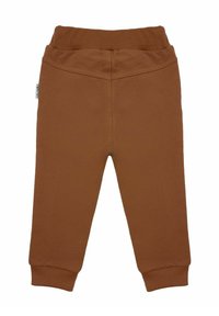 Brązowe spodnie dla malucha z elastycznym pasem i ściągaczami przy nogawkach, zaprojektowane z myślą o komforcie i swobodzie ruchów.