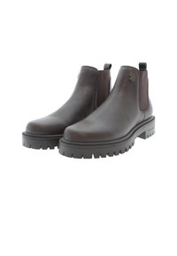 Botas Chelsea de cuero marrón con paneles laterales elásticos, suelas texturizadas y un acento de logo. Presentan una punta redondeada y una suela de goma resistente.