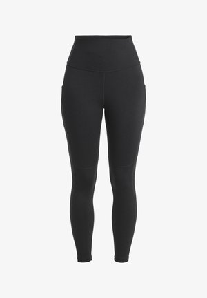 Leggings negros de cintura alta fabricados con tejido elástico, que cuentan con bolsillos laterales y una textura suave con costuras reforzadas.