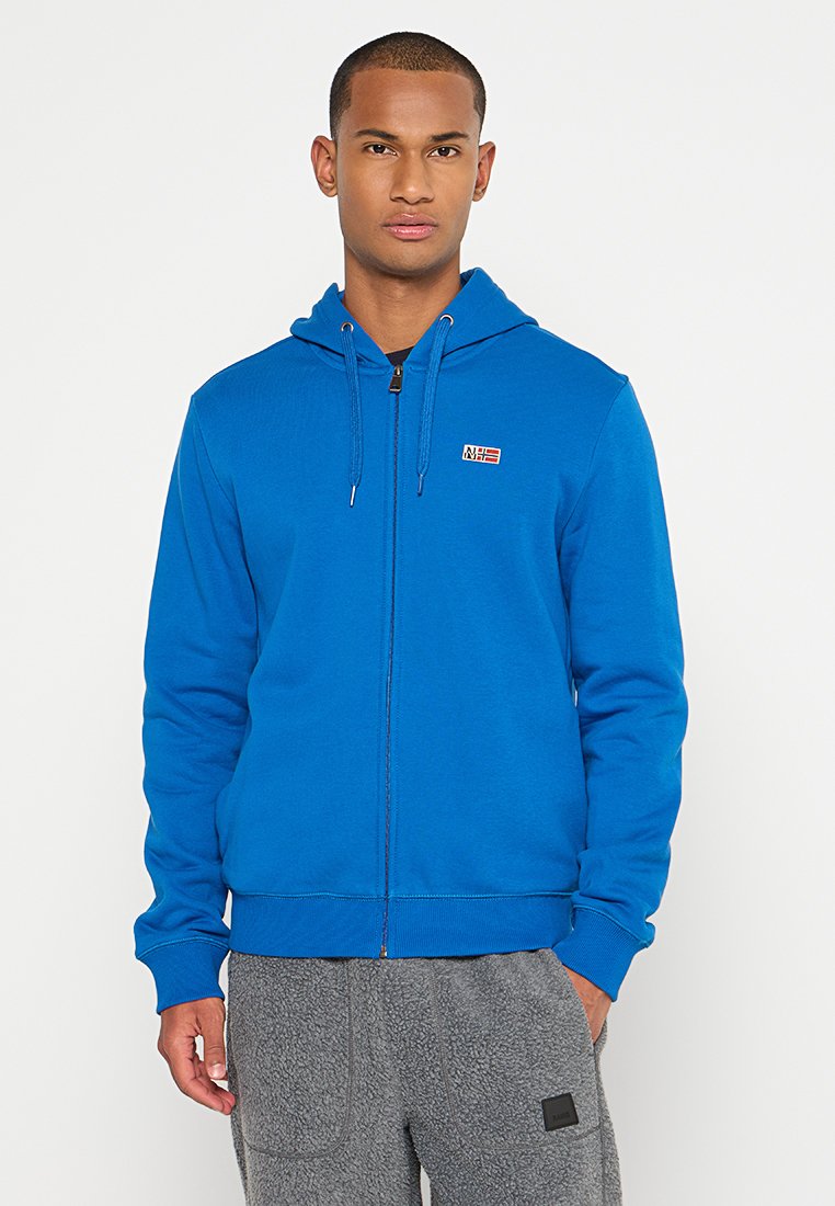 Hoodie bleu zippé avec capuche à cordon de serrage et petit logo sur la poitrine. Fabriqué en tissu doux avec des poignets et une taille côtelés.