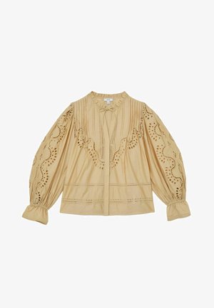 Blouse beige à manches longues avec détails en dentelle à œillets, col volanté, plis pincés et cordon à nouer au niveau de l’encolure.