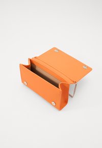 Orange synthetic material clutch with snap closure and chain strap, featuring a smooth texture and a single spacious compartment inside.