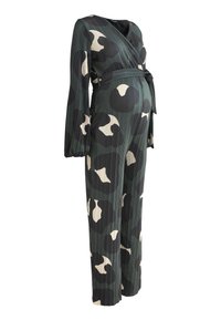 Combinaison de maternité à manches longues avec un motif floral abstrait vert, noir et beige sur fond blanc, accompagnée d'un lien à la taille.