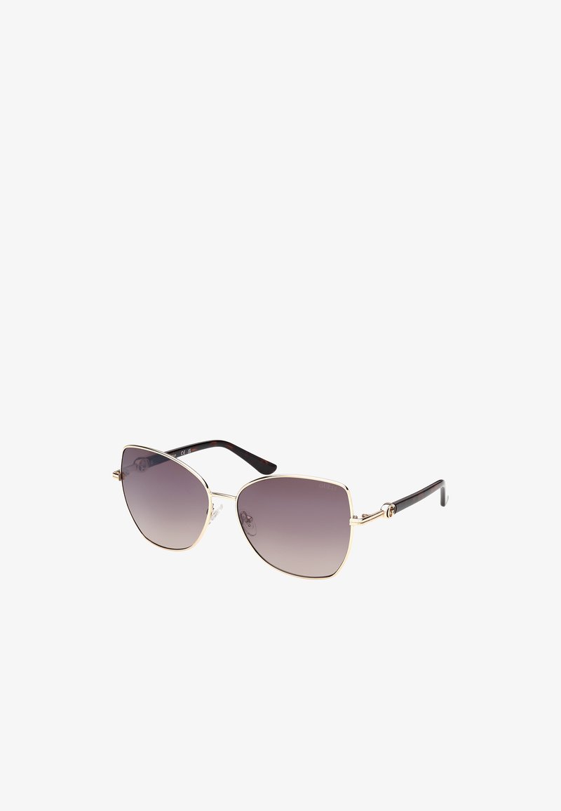 Occhiali da sole a occhio di gatto con lenti grigie sfumate, montatura in metallo dorato e braccia con motivo tartaruga. Dotati di cuscinetti per il naso per il massimo comfort.