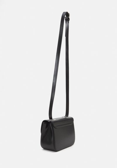 Black leather crossbody bag with a smooth texture, rectangular shape, flat flap, and adjustable strap. Features silver hardware accents.