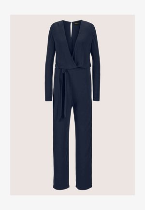 Navyblauwe jumpsuit van zacht materiaal met lange mouwen, een diepe V-hals en een tailleband. Heeft wijde pijpen en een sleutelgatdetail op de rug.