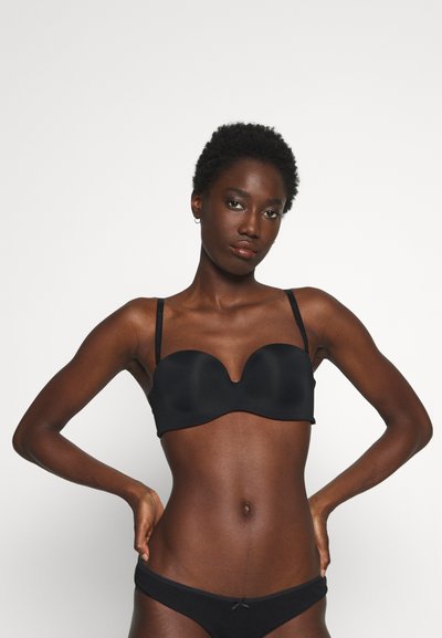 Black padded bra with a smooth texture and a heart-shaped neckline, complemented by adjustable straps. Simple, minimalistic design.