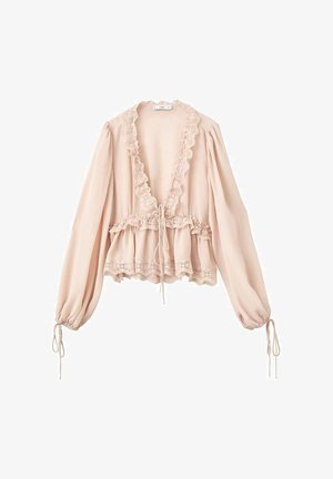 Blush pink blouse with long sleeves, ruffled neckline, drawstring waist, and lace trim at the cuffs and hem. Lightweight, textured fabric.