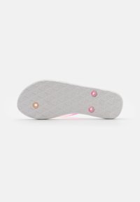 Suola di scarpa in materiale gommoso bianco texturizzato, con accenti rosa e fori circolari per il fissaggio. Modello geometrico visibile sulla superficie.