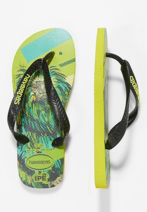 Dziecięce japonki Havaianas z neonowo żółtą podeszwą, czarnymi paskami i kolorowym wzorem twarzy leniwca na teksturowanej wkładce.