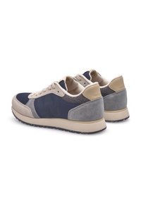 Navy and gray sneakers featuring a combination of mesh, suede, and leather materials, with a textured design and beige accents.