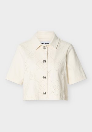 Short-sleeve, cream cropped shirt with collar, decorative perforated diamond and floral patterns, and four silver buttons down the front.