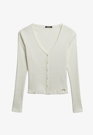 Weißer gerippter Cardigan mit langen Ärmeln, V-Ausschnitt, Knopfleiste, cropped Saum und einem dezenten Markenschild auf der unteren rechten Seite.