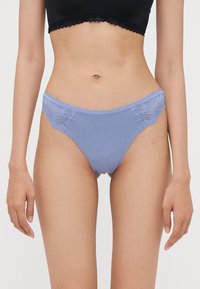 Light blue thong with lace accents on the sides, featuring a soft texture. Elastic waistband provides a smooth fit.