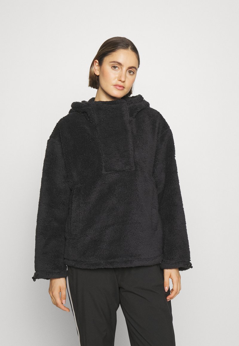 Schwarzer Fleecepullover mit hohem Kragen, übergroßer Kapuze und Fronttasche. Weiche Textur und lange Ärmel für Wärme.