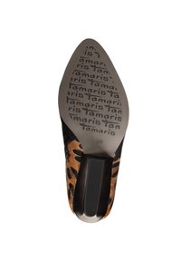 Chaussure à bout pointu avec une tige imprimée léopard marron et noire. Présente un talon noir lisse et une semelle grise texturée avec un logo de marque.