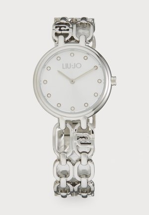 Silver-tone watch with a round white face, featuring decorative hour markers and a linked bracelet design with alternating solid and cutout links.