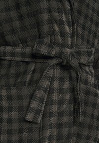 Mørkternet robe med en blød corduroy-textur, der har et bånd i taljen og en lomme på fronten. De dominerende farver er mørkegrå og sort.