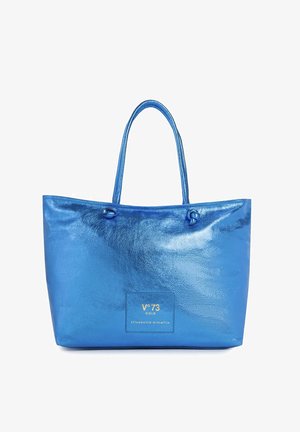 Sac cabas bleu brillant avec doubles poignées, forme rectangulaire et logo "V°73 Gold Elisabetta Armellin" au centre avant.