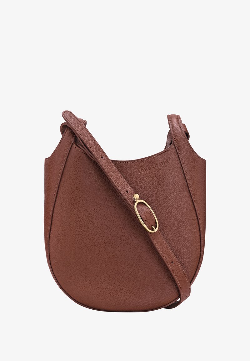 Brown leather shoulder bag with pebbled texture, curved shape, adjustable strap, and gold-tone hardware detail. Logo embossed on front.