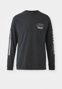 Long-sleeve black T-shirt made of cotton. Features white text graphics on the left chest and along the right sleeve. Crew neckline, relaxed fit.