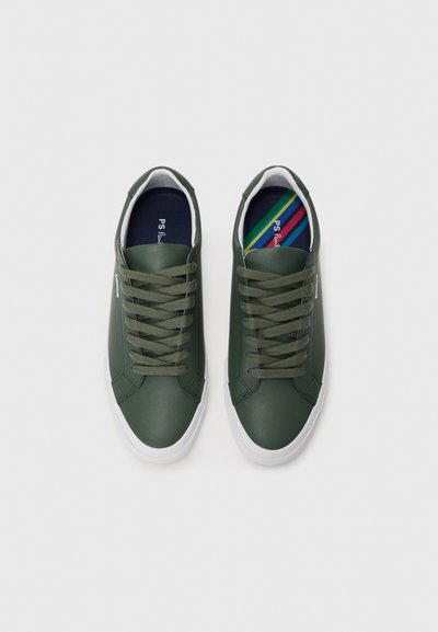 Green synthetic sneakers with white soles, featuring round laces, a smooth texture, and a colorful striped insole pattern.