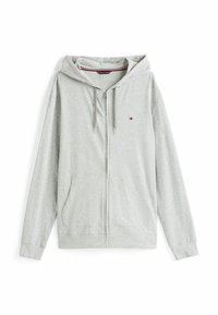 Sudadera con cremallera de color gris claro, fabricada con material suave, que presenta una capucha con cordón, dos bolsillos frontales y un pequeño logo en el pecho.