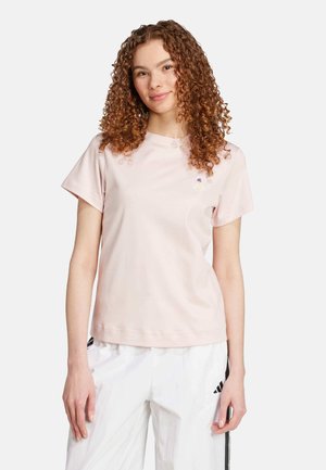 Light pink cotton t-shirt with short sleeves, crew neckline, and small embroidered design on the chest. Smooth texture, casual fit.