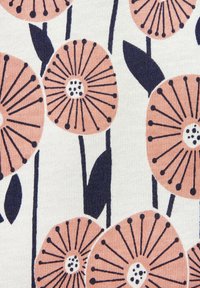 Floral fabric with large peach flowers and navy blue accents, featuring round petals, thin stems, and dark green leaves on a cream background.