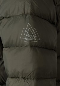 Dark green padded jacket with stitched logo of overlapping triangles, "1997," and the word "RESPECT" on the sleeve.