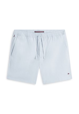 Bañador corto azul claro para hombre con cintura elástica, cordón, bolsillos laterales y pequeño logo de bandera roja, blanca y azul en la pierna y el bolsillo.